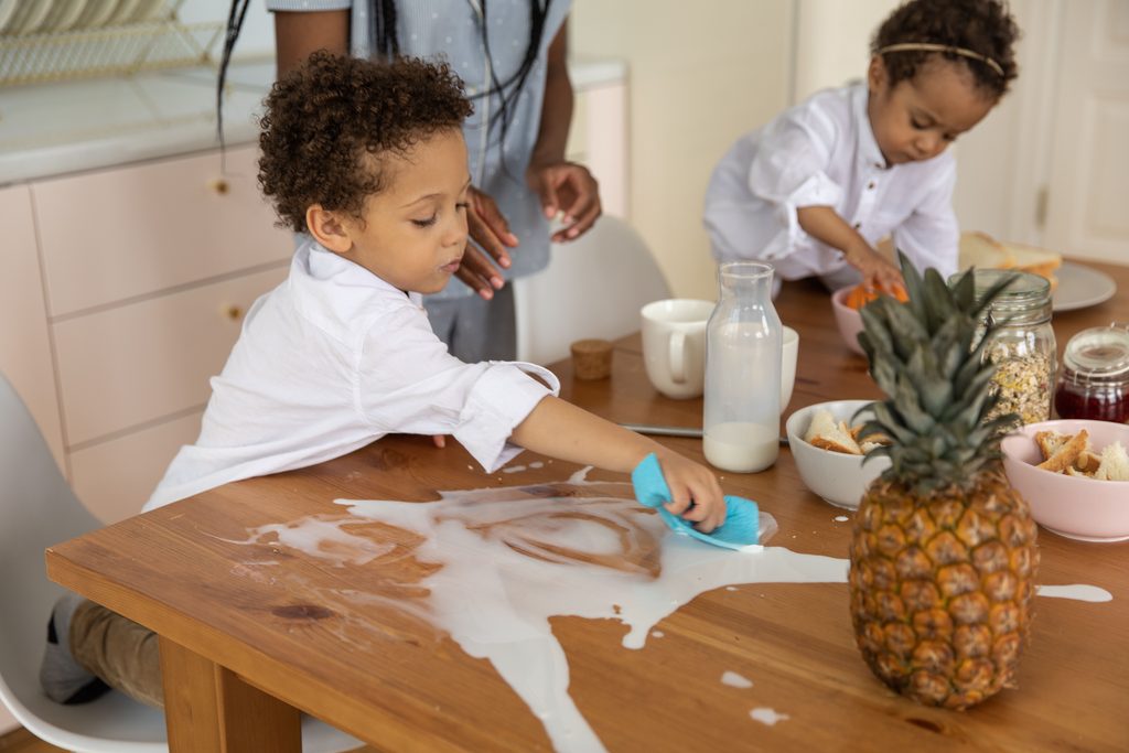 A kitchen counter being wiped, showing how to keep a clean house with kids