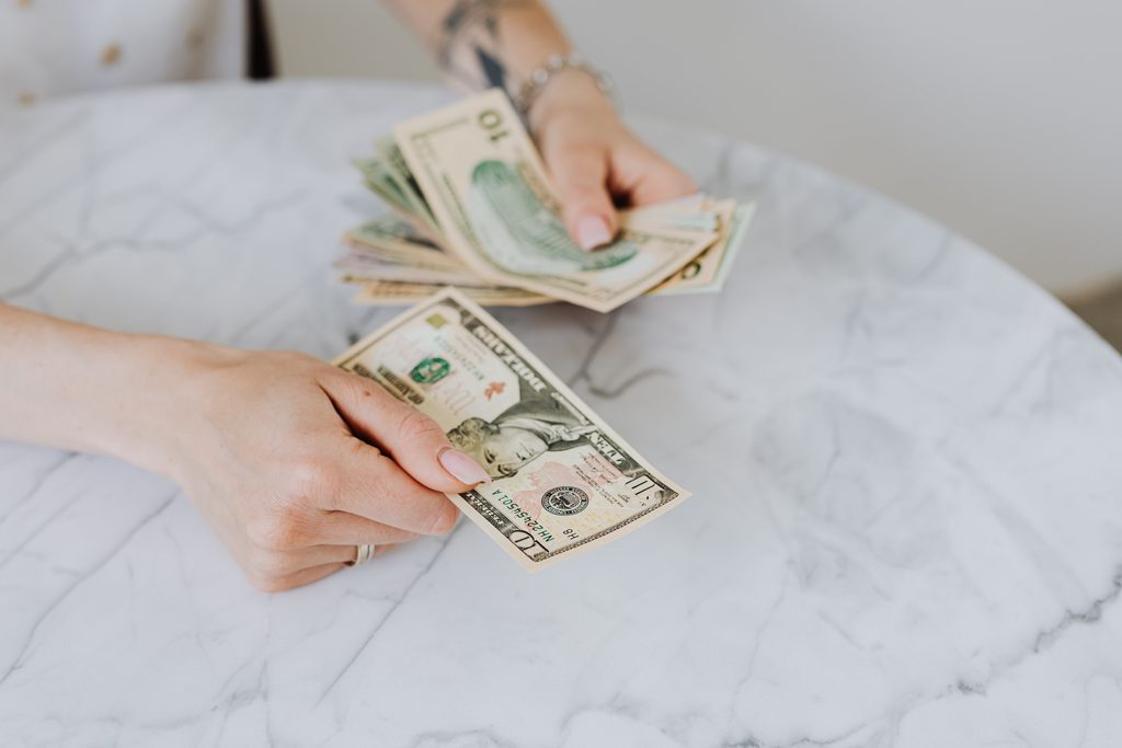 Frugal living tips for families, a kitchen table with a budget and a grocery list