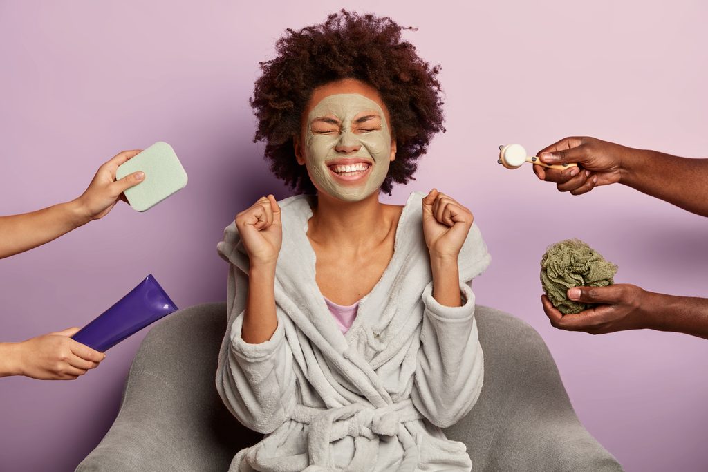 Self-care on a budget, Overjoyed woman in bathrobe clenches fists with happiness