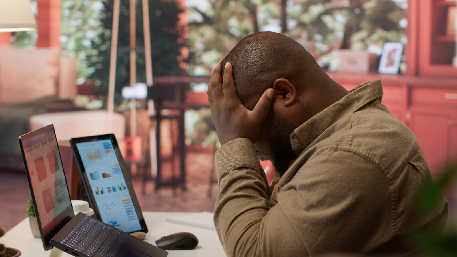 Emotional spending triggers: a laptop open on a shopping app beside a bank balance