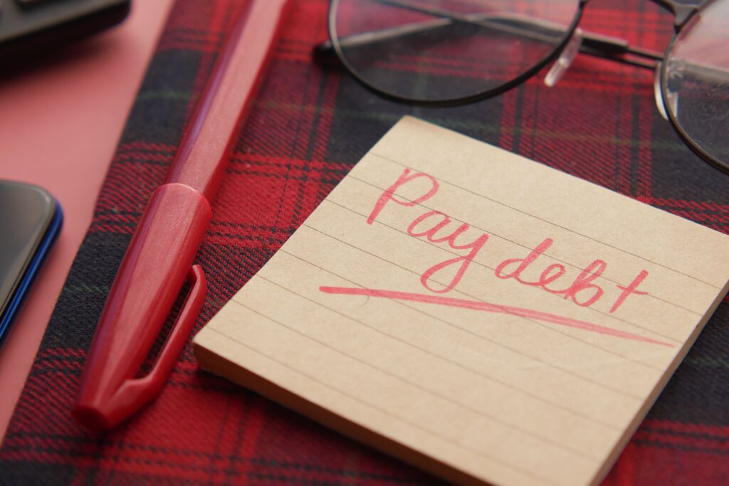 Benefits of being debt free, a paid-off credit card statement beside a savings account balance